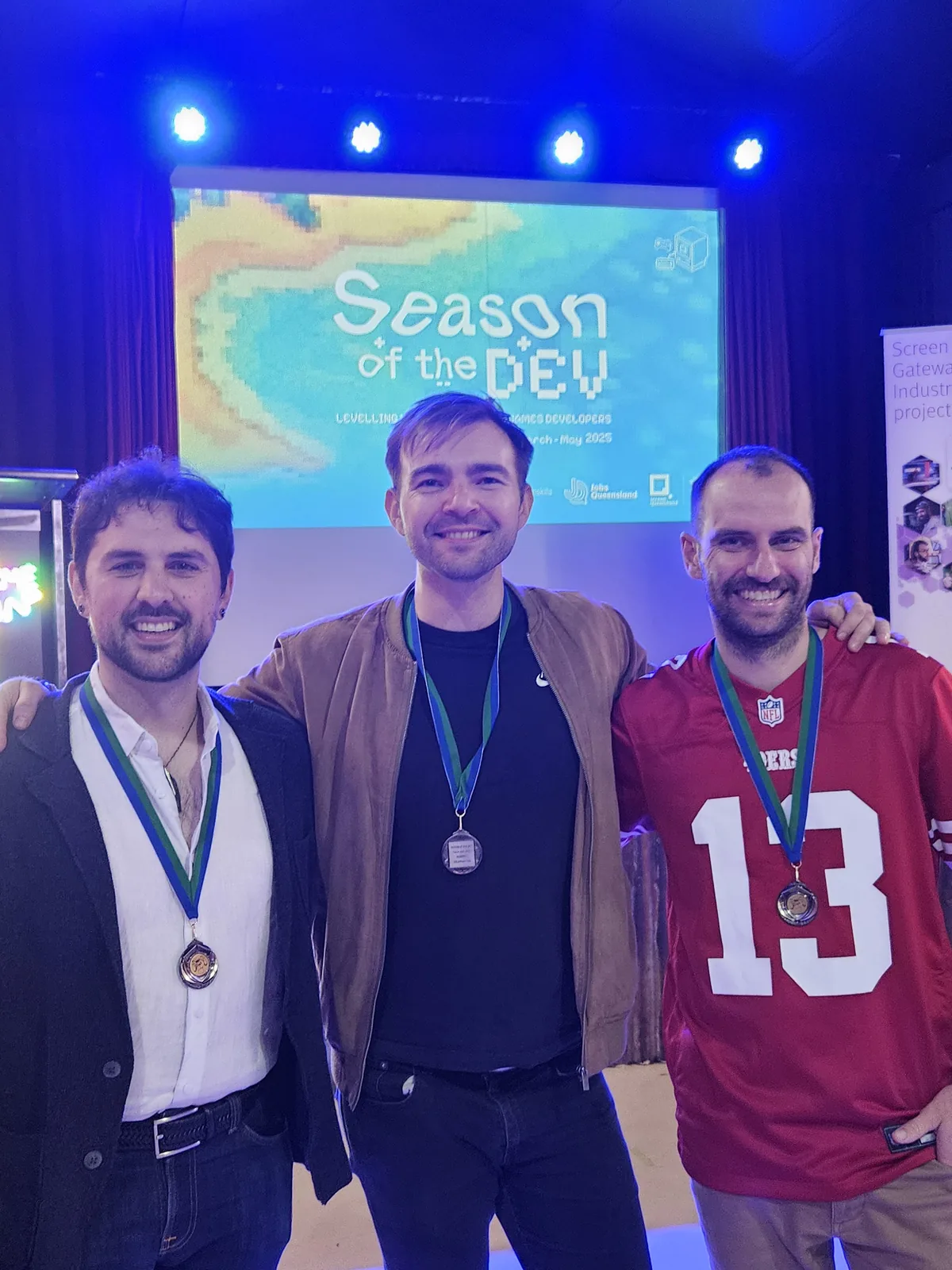 Seb with two fellow speakers at a games industry event.
