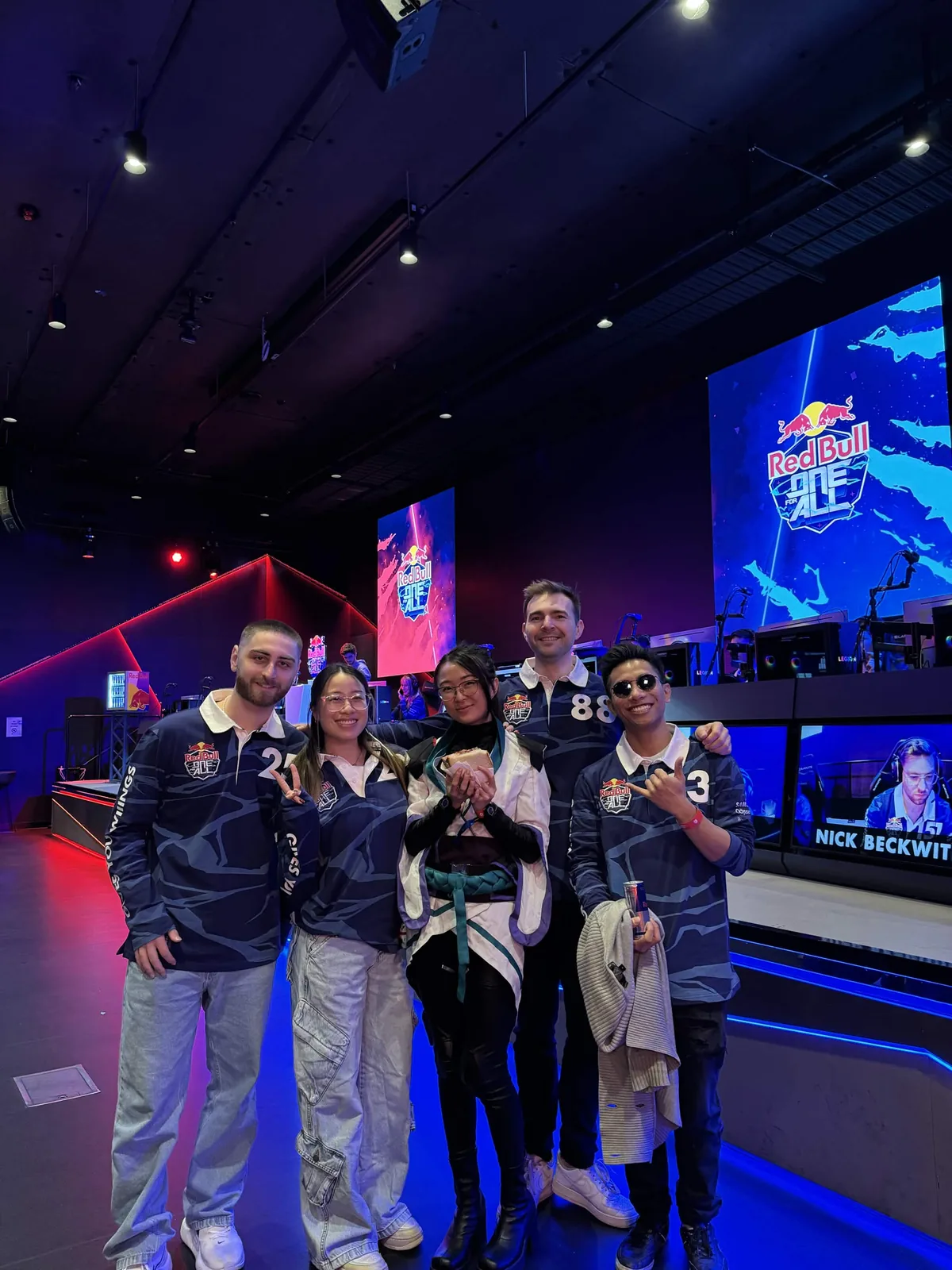 Seb and teammates together on a gaming event stage.
