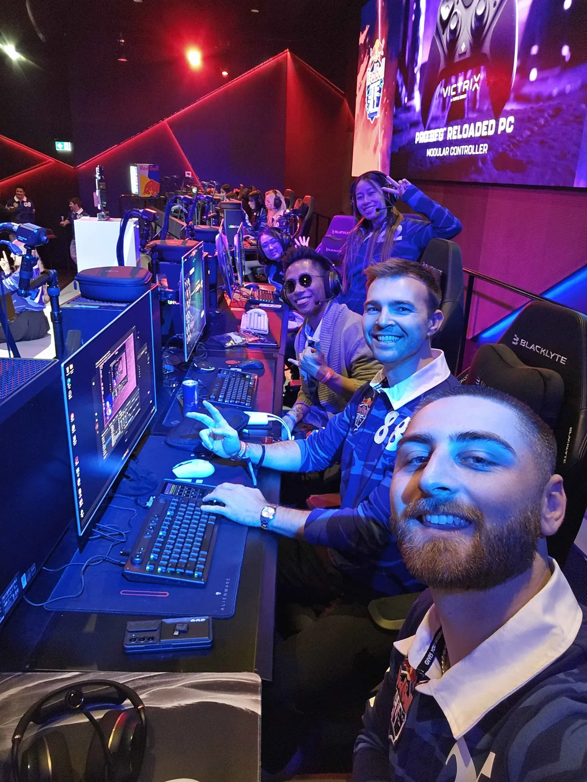 Seb seated at a computer with fellow developers during a live build event.