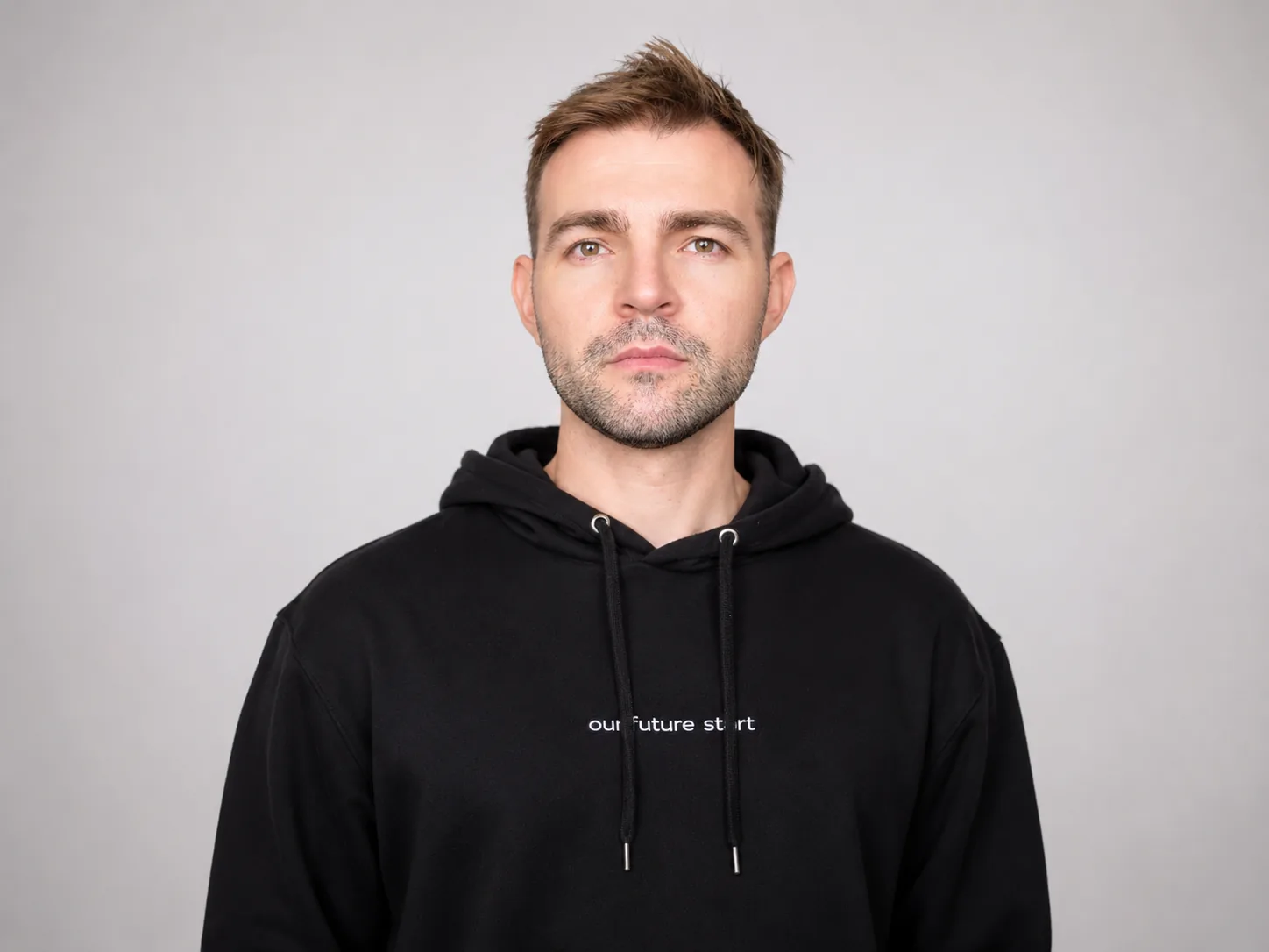 Studio portrait of Seb against a white background.
