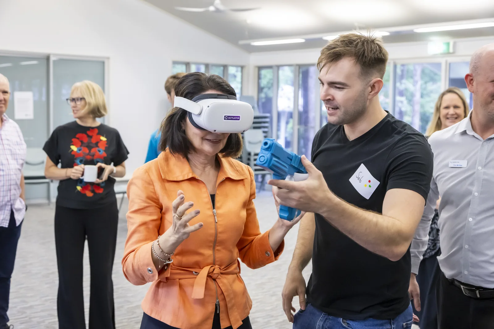 Seb assisting an attendee during a virtual reality demonstration.